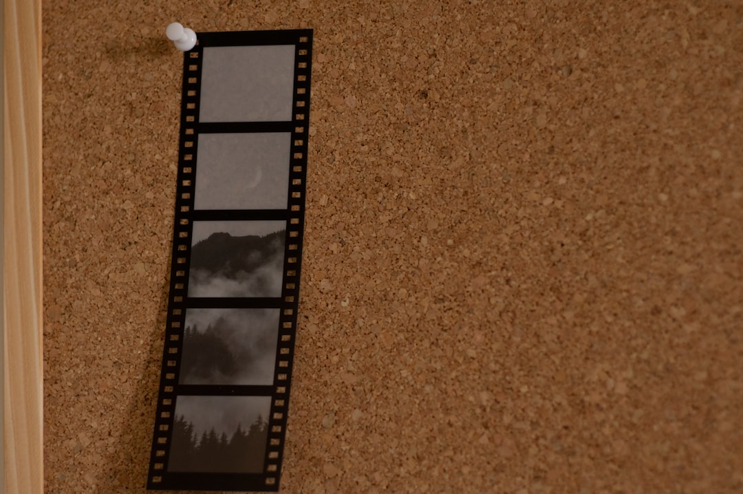 a film strip hanging on a cork wall