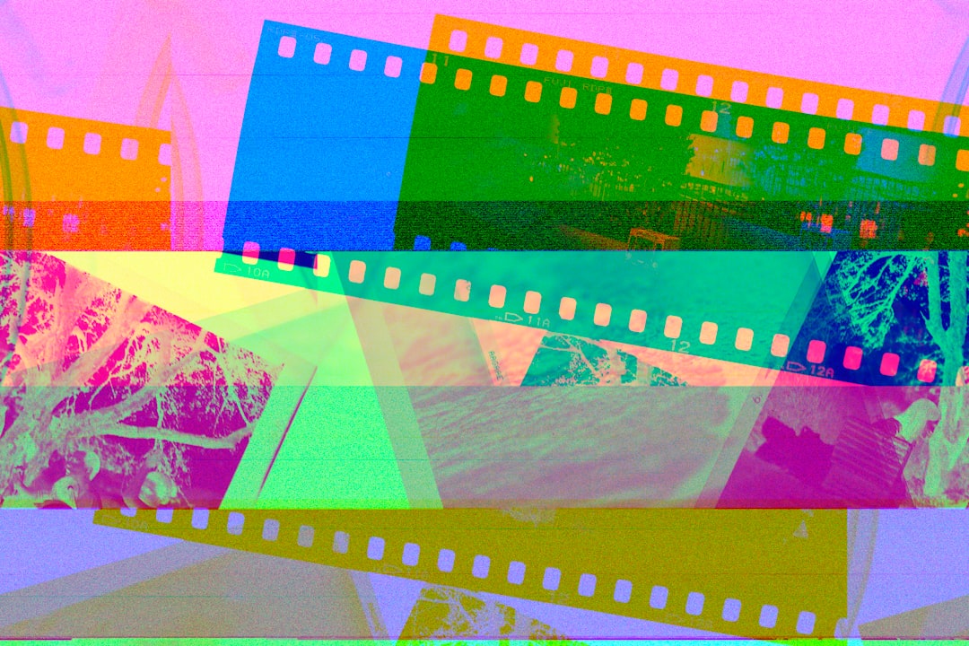 a multicolored film strip with a picture of a mountain in the background